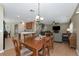 Bright dining room features a wooden table with seating for six and views into the living room and kitchen at 24911 Oakhaven Ct, Lutz, FL 33559