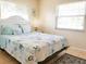 Bright bedroom with a queen-size bed and coastal bedding at 3405 Highland W Ave, Bradenton, FL 34205