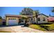 Charming one-story home features an attached garage and a well-maintained yard with mature landscaping at 3405 Highland W Ave, Bradenton, FL 34205