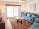 Bright living room with comfy blue sofa and wood floors at 3405 Highland W Ave, Bradenton, FL 34205