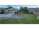 View of the front of the house, including the driveway and landscaping at 3409 Avenida Madera # A, Bradenton, FL 34210