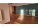 Bright living room with wood-look floors and a teal accent wall at 3409 Avenida Madera # A, Bradenton, FL 34210