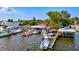 Aerial view of waterfront property with boats, docks, and a restaurant at 3601 E Bay Dr # 203, Holmes Beach, FL 34217