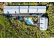 Aerial view showing community pool and building exteriors at 3601 E Bay Dr # 203, Holmes Beach, FL 34217