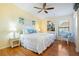 King bed, hardwood floors, and coastal decor in this tranquil bedroom at 3601 E Bay Dr # 203, Holmes Beach, FL 34217