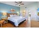 King bed, wicker furniture, and coastal-themed decor at 3601 E Bay Dr # 203, Holmes Beach, FL 34217