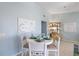 Coastal-themed dining area with white table and four chairs at 3601 E Bay Dr # 203, Holmes Beach, FL 34217