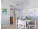 Small dining area with white table and chairs, beach-themed art at 3601 E Bay Dr # 203, Holmes Beach, FL 34217