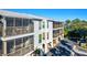Two-story building with screened balconies overlooking a parking area at 3601 E Bay Dr # 203, Holmes Beach, FL 34217