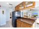 Kitchen features wood cabinets, breakfast bar and black appliances at 3601 E Bay Dr # 203, Holmes Beach, FL 34217