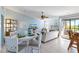 Open living area with a comfy sofa, dining table, and coastal decor at 3601 E Bay Dr # 203, Holmes Beach, FL 34217