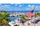 Beautiful marina with numerous boats and an American flag waving at 3601 E Bay Dr # 203, Holmes Beach, FL 34217