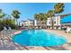 Inviting community pool with lounge chairs and umbrellas at 3601 E Bay Dr # 203, Holmes Beach, FL 34217