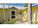 Front entrance with arched window and palm trees at 3811 5Th W Ave, Palmetto, FL 34221