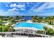 Stunning aerial view of resort-style pool with bayfront views at 396 Aruba Cir # 103, Bradenton, FL 34209