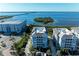 Aerial view of waterfront community with three buildings near the marina at 396 Aruba Cir # 103, Bradenton, FL 34209