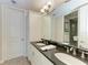 Elegant bathroom with double vanity, granite countertops, and a large mirror at 396 Aruba Cir # 103, Bradenton, FL 34209