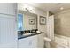 Well-appointed bathroom with a tub, shower, and granite vanity at 396 Aruba Cir # 103, Bradenton, FL 34209