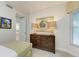 Small bedroom with twin bed and dresser, view of kitchen at 396 Aruba Cir # 103, Bradenton, FL 34209
