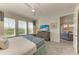 Spacious bedroom with king-size bed, TV, and view into adjacent living area at 396 Aruba Cir # 103, Bradenton, FL 34209
