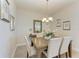 Bright dining room with a rustic wooden table and chandelier at 396 Aruba Cir # 103, Bradenton, FL 34209