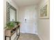 Condo entryway featuring a console table, mirror, and neutral color palette at 396 Aruba Cir # 103, Bradenton, FL 34209