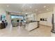 Open concept kitchen with white cabinets, a large island, and stainless steel appliances at 396 Aruba Cir # 103, Bradenton, FL 34209