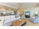 Spacious living room with open kitchen, dining, and TV area at 396 Aruba Cir # 103, Bradenton, FL 34209