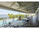 Covered outdoor patio overlooking the pool and bay with tables and chairs at 396 Aruba Cir # 103, Bradenton, FL 34209