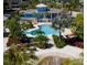 Resort-style pool with a cabana and lush landscaping at 396 Aruba Cir # 103, Bradenton, FL 34209