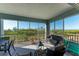 Spacious screened balcony overlooking water with seating for relaxing at 396 Aruba Cir # 103, Bradenton, FL 34209