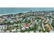 Aerial view of a house near the beach, with a neighborhood and ocean visible at 421 Island Cir, Sarasota, FL 34242