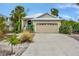 Charming house with a metal roof, two-car garage, and landscaped yard at 421 Island Cir, Sarasota, FL 34242