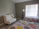 Spacious bedroom with twin beds, ample natural light, and a sofa at 4470 Weybridge # 68, Sarasota, FL 34235
