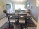 Bright dining room with table and chairs, hardwood floors at 4470 Weybridge # 68, Sarasota, FL 34235