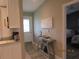 Bright entryway with console table and view to the kitchen at 4470 Weybridge # 68, Sarasota, FL 34235
