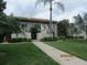 Attractive condo building with lush landscaping and walkway at 4470 Weybridge # 68, Sarasota, FL 34235
