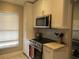 Updated kitchen showcasing stainless steel appliances and granite countertops at 4470 Weybridge # 68, Sarasota, FL 34235