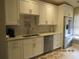 Modern kitchen with white cabinets, granite countertops, and updated sink at 4470 Weybridge # 68, Sarasota, FL 34235