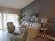 Comfortable living room with light-colored furniture and accent wall at 4470 Weybridge # 68, Sarasota, FL 34235