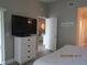 Main bedroom with large TV and access to second bathroom at 4470 Weybridge # 68, Sarasota, FL 34235