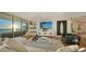 Bright living room with ocean view, featuring a comfy sofa and large TV at 535 Sanctuary Dr # C408, Longboat Key, FL 34228