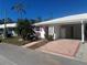 White single-story home with pink door and a paved driveway at 541 Spanish N Dr # 541, Longboat Key, FL 34228