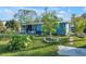 Backyard view of a light blue home with landscaping at 607 2Nd Nw Ave, Ruskin, FL 33570