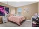 Cozy bedroom featuring a pink bedding set and a hanging chair at 6138 Colmar Pl, Apollo Beach, FL 33572