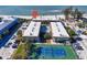 Aerial view highlighting beachfront property with pool and tennis court at 7100 Gulf Dr # 112, Holmes Beach, FL 34217