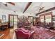 Living room with hardwood floors, exposed beams, and comfortable seating at 713 Eagle Point Dr, Venice, FL 34285