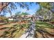 Inviting front yard with lush landscaping and a paved walkway leading to the entrance at 7217 N Serenoa Dr, Sarasota, FL 34241