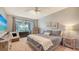 Spacious bedroom with a king-size bed and access to a private balcony at 7320 Golf Pointe Cir, Sarasota, FL 34243