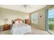 Guest bedroom with twin beds, dresser, and view of water at 1257 Burgos Dr # 302, Sarasota, FL 34238